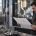 Engineer reviewing a CAD drawing beside a CNC machining center