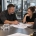 Machine shop owner and estimator reviewing opportunity records and a machined part